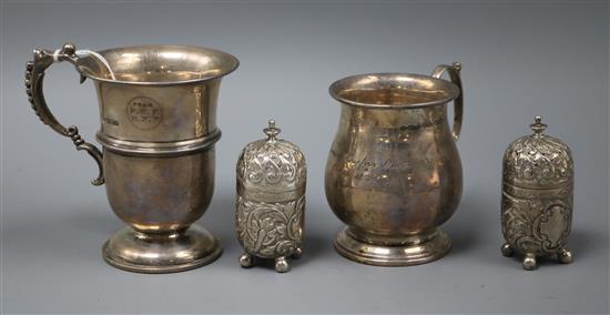 Two 20th century silver christening cups and a pair of late Victorian silver pepperettes.